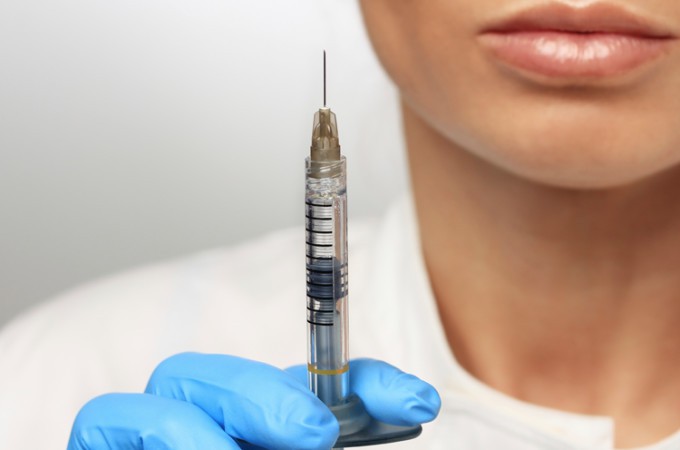 Image of a female doctor holding a syringe