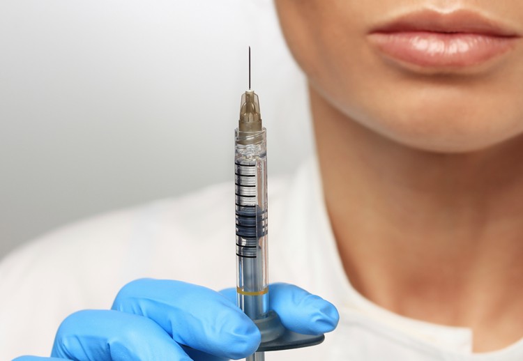 Image of a female doctor holding a syringe